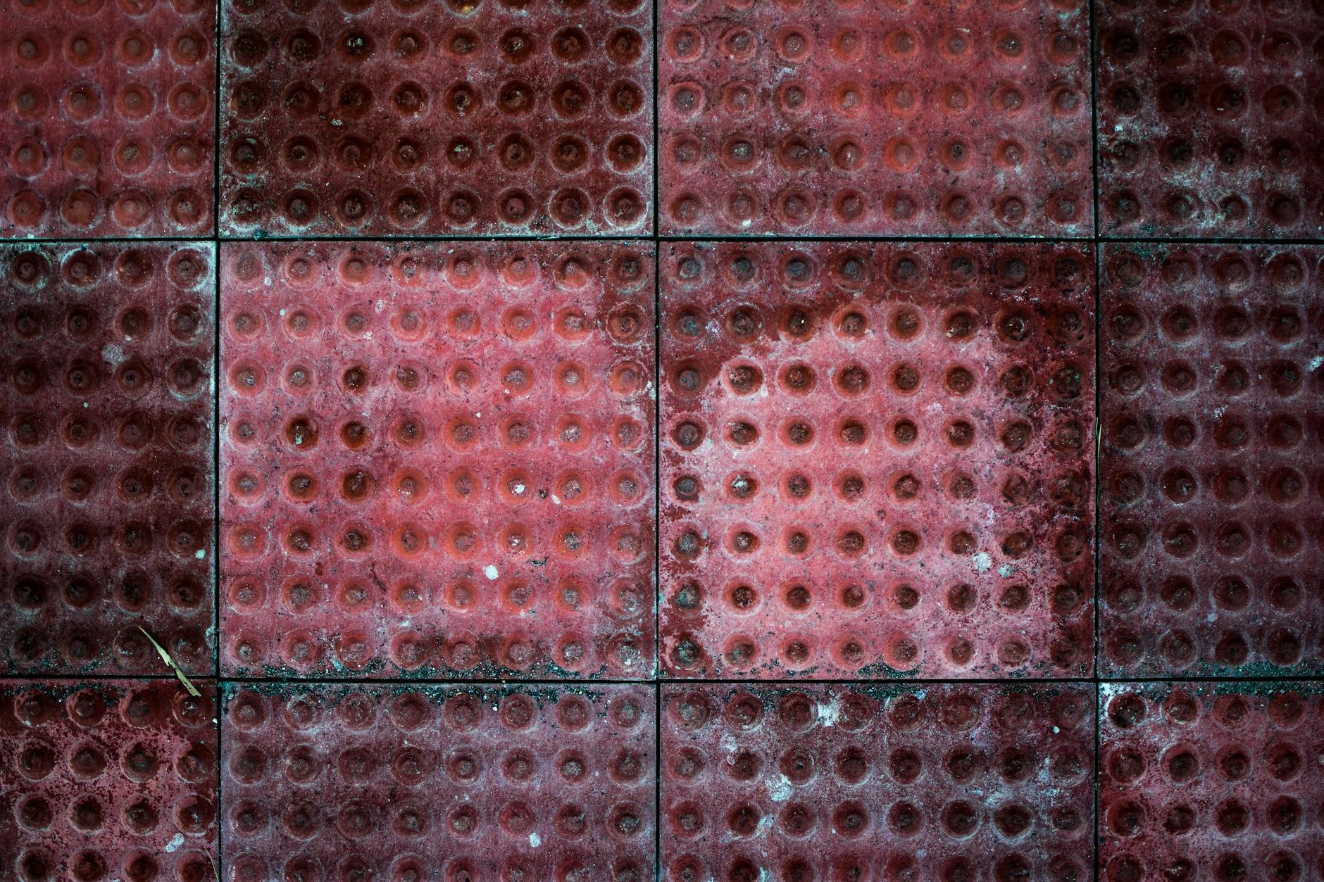 Cracked and discolored grout lines in tile floor